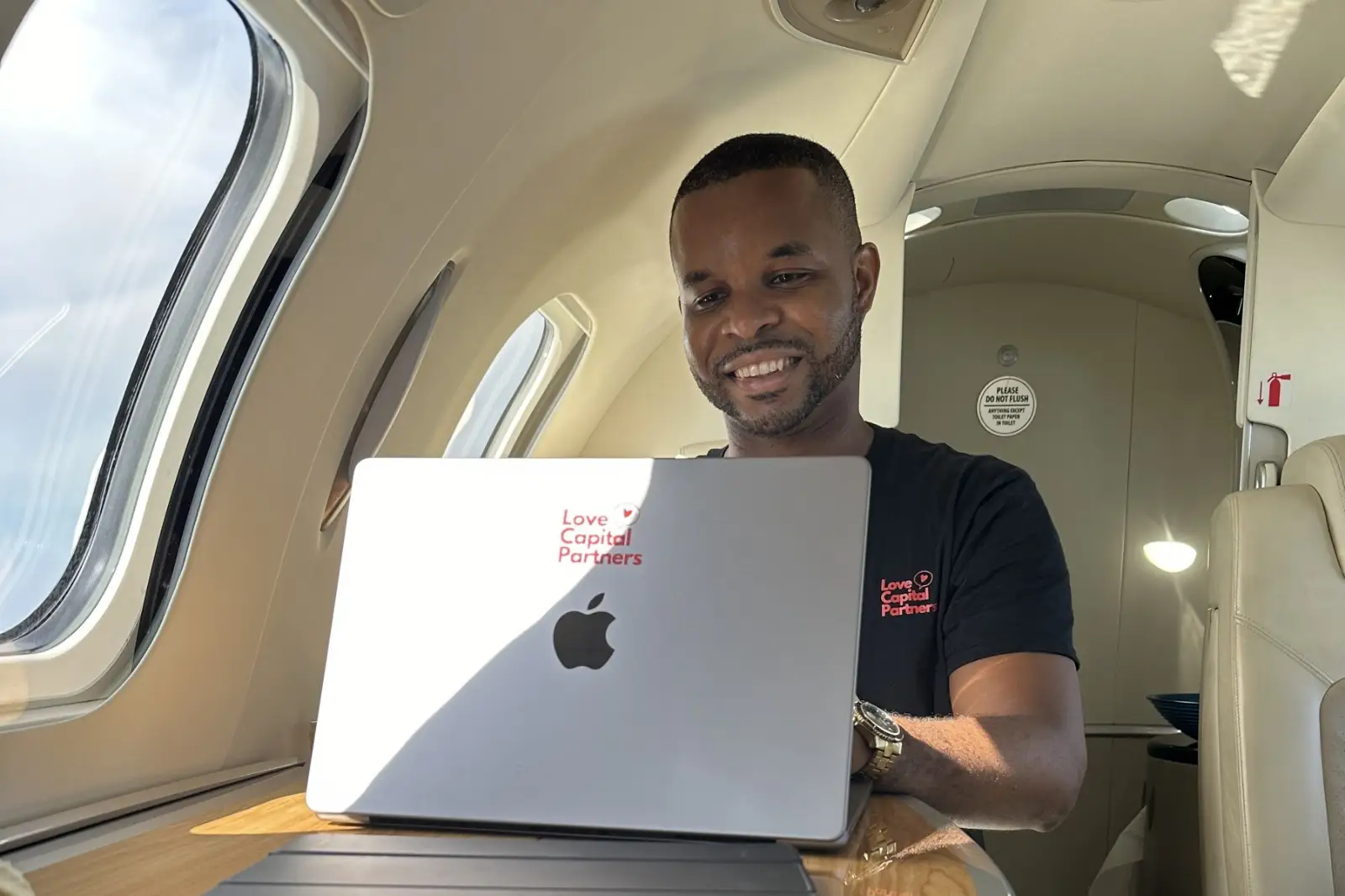 Merrick Lee working on a laptop while traveling