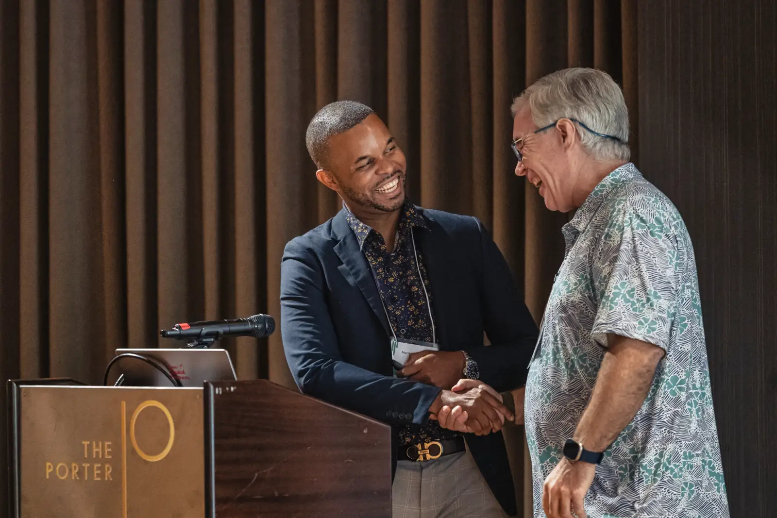 Merrick Lee shaking hands with an attendee after a talk