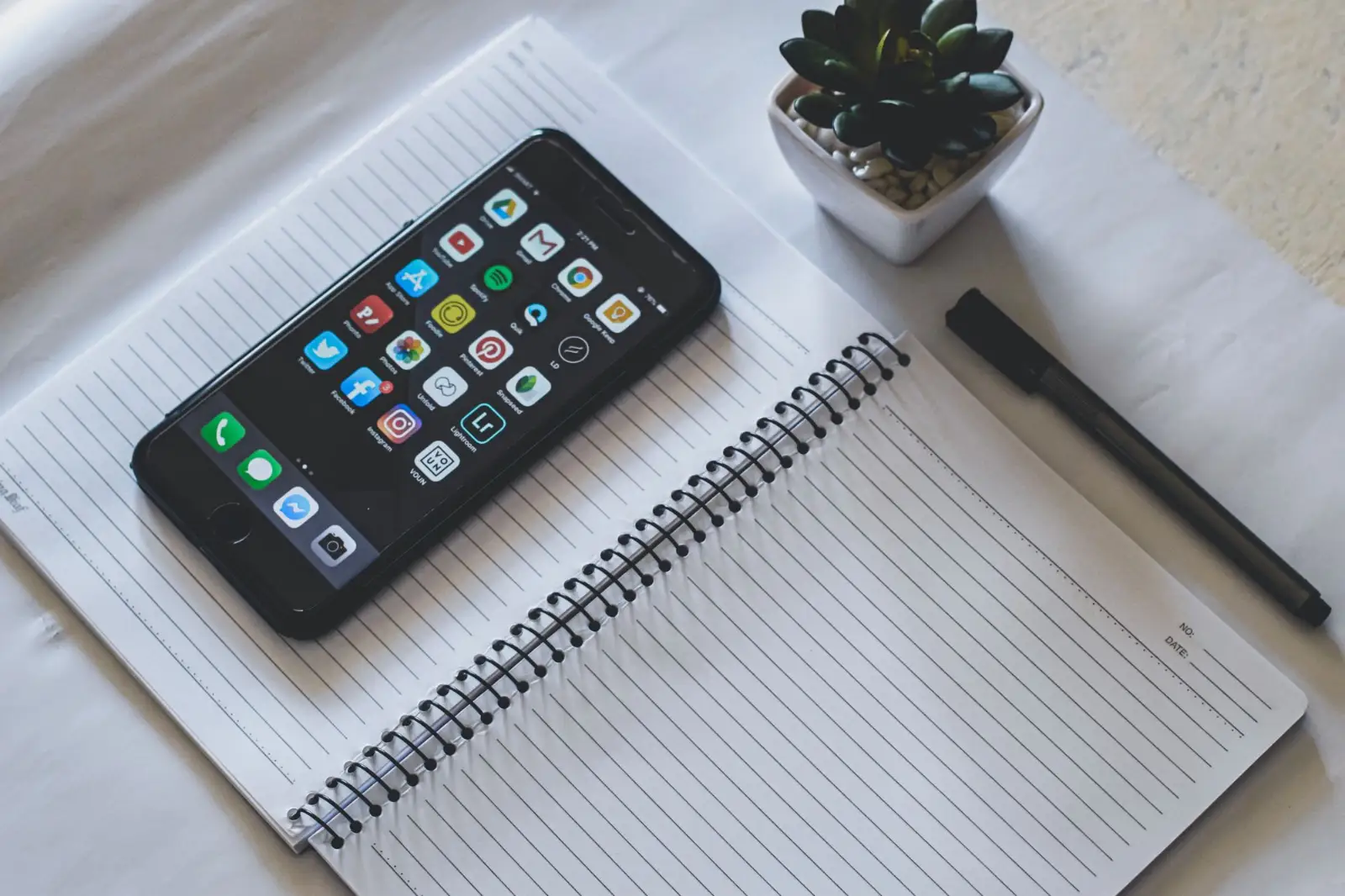 Smartphone resting on an open notebook, ready for a follow-up audit
