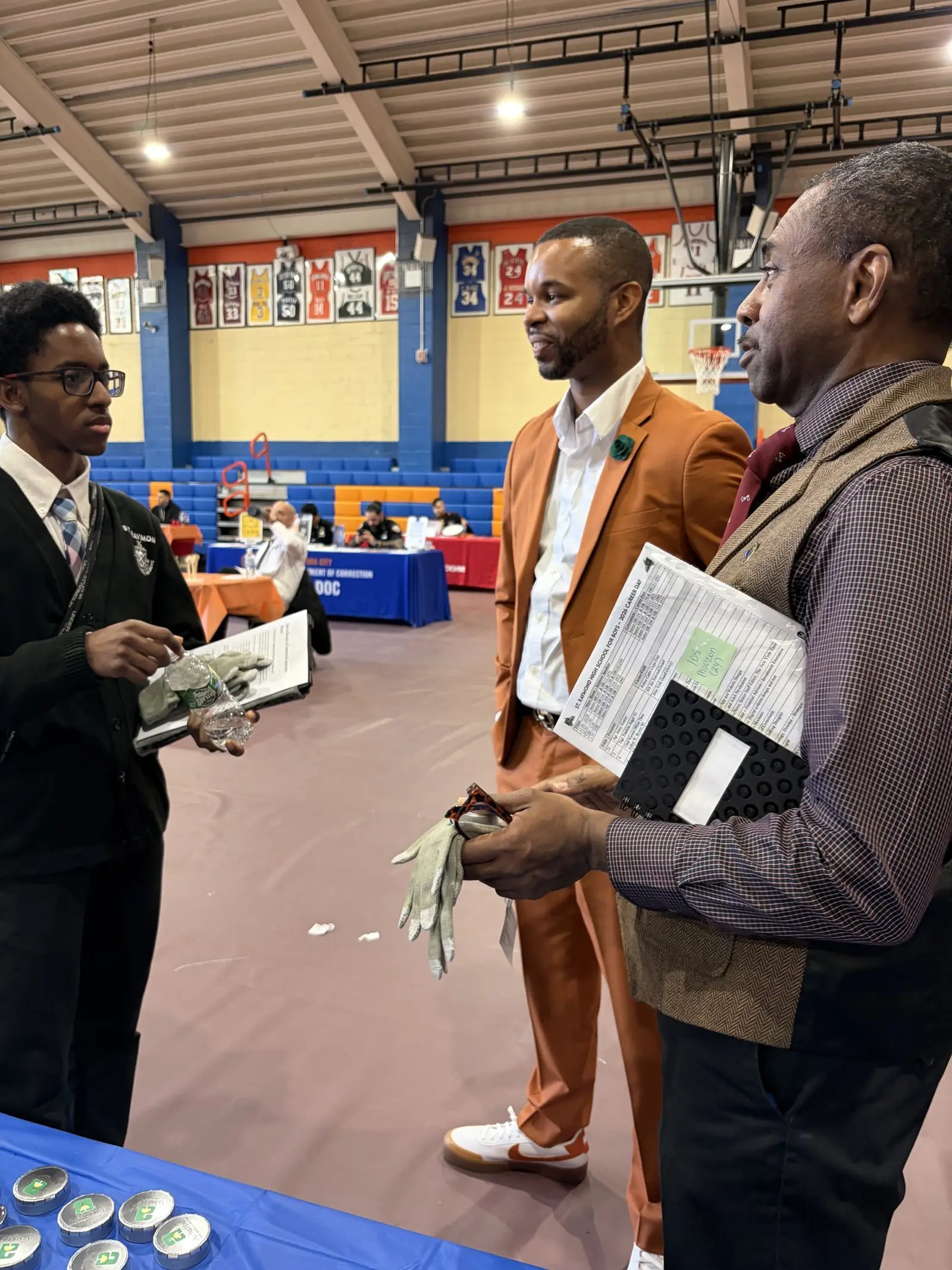 Merrick Lee Jr. talking with a teacher at the St. Raymond High School for Boys career day
